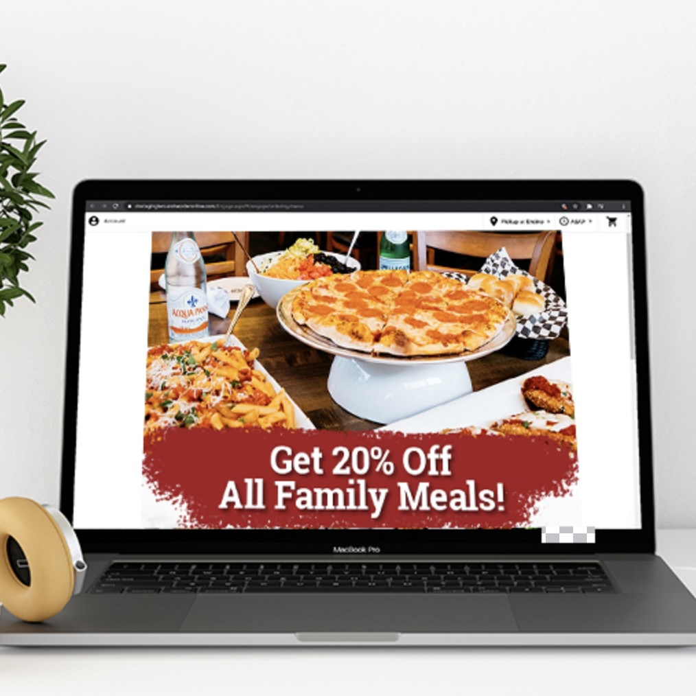 a laptop showing "get 20% off all family meals!"