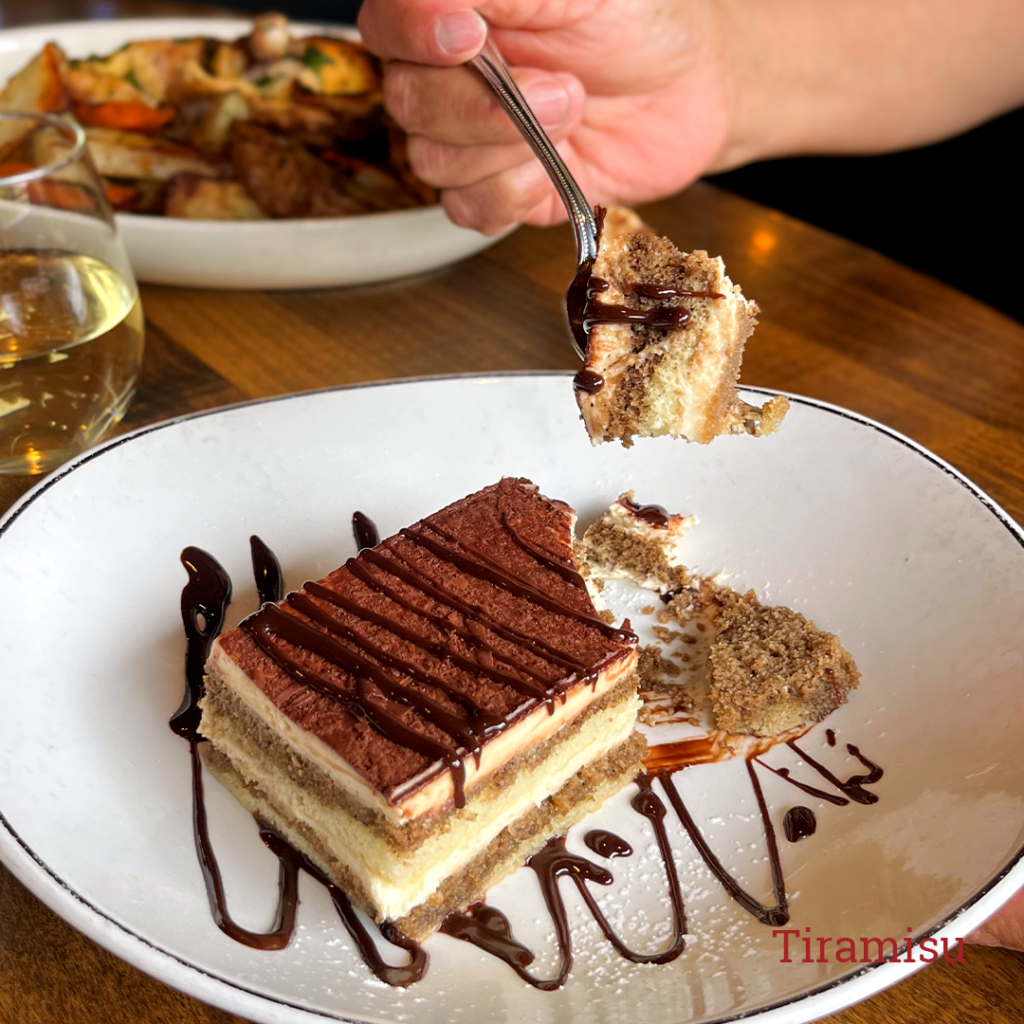 Someone taking a fork-full of tiramisu