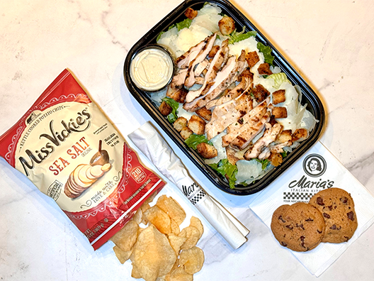 caesar salad lunch box with chips and cookie