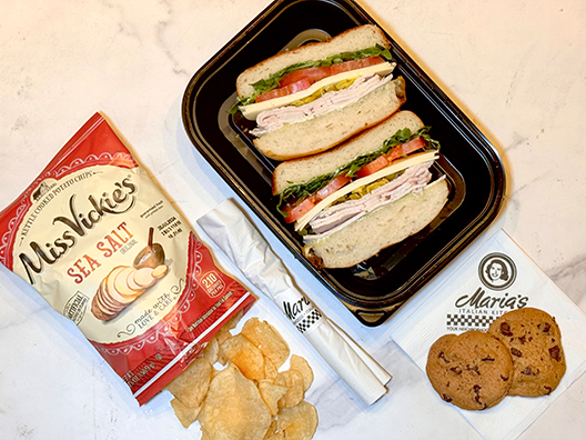 turkey sandwich lunch box with chips and cookie